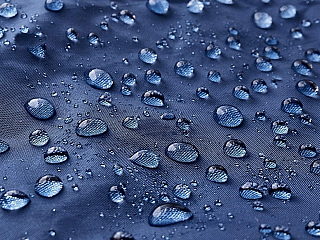 Rain water droplets on waterproof fabric.